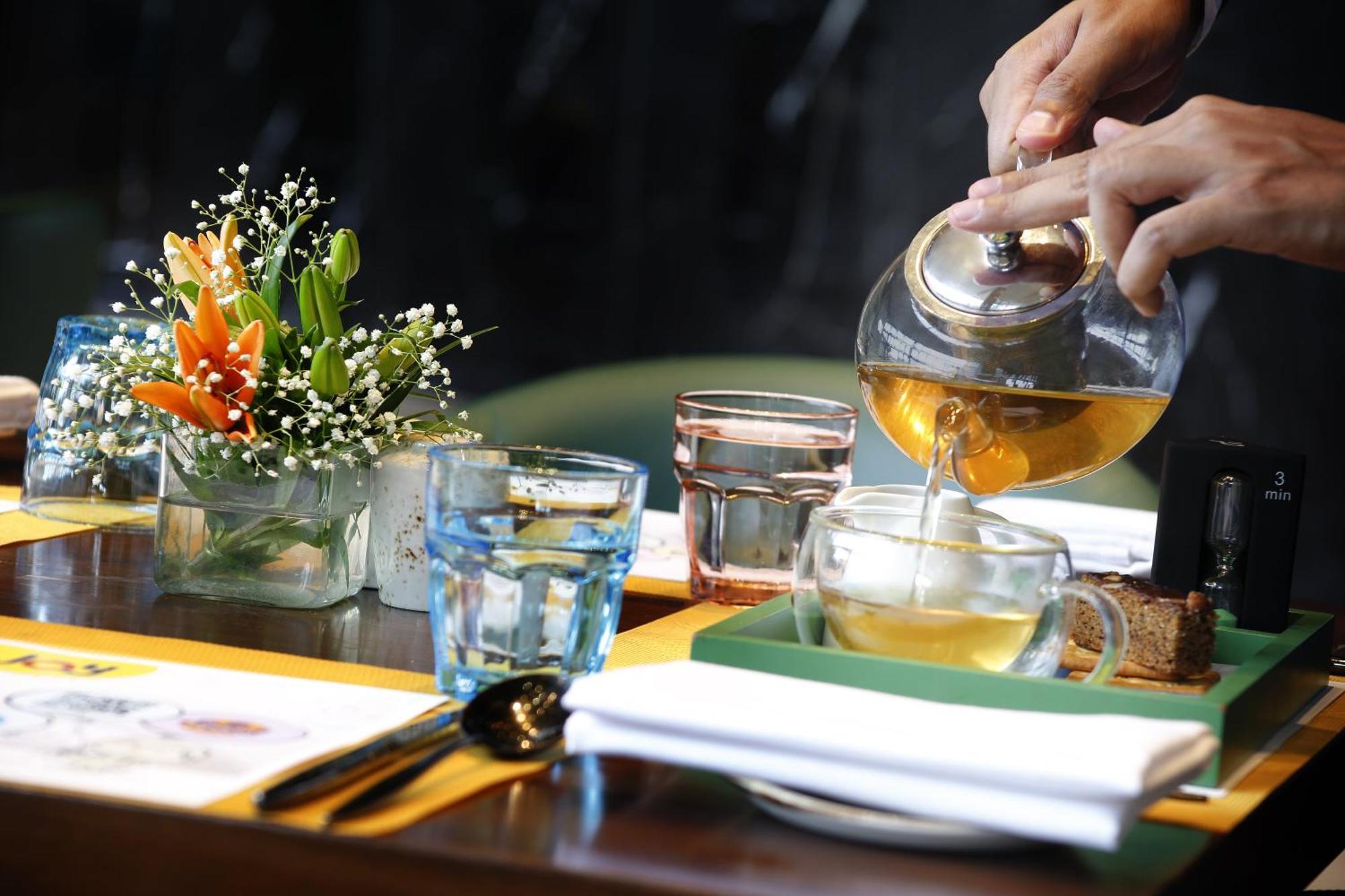 Novotel Kolkata Hotel&Residences Exterior foto A server pours tea at a restaurant